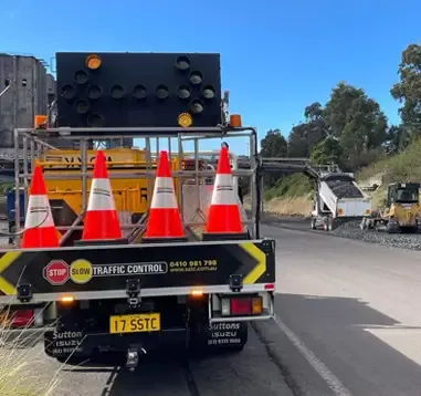 An SSTC ute with arrow board and cones on a suburban road