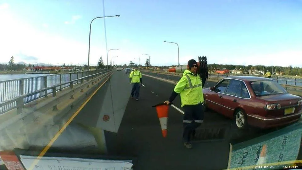 Dash camera still: a traffic controller and a stopped car