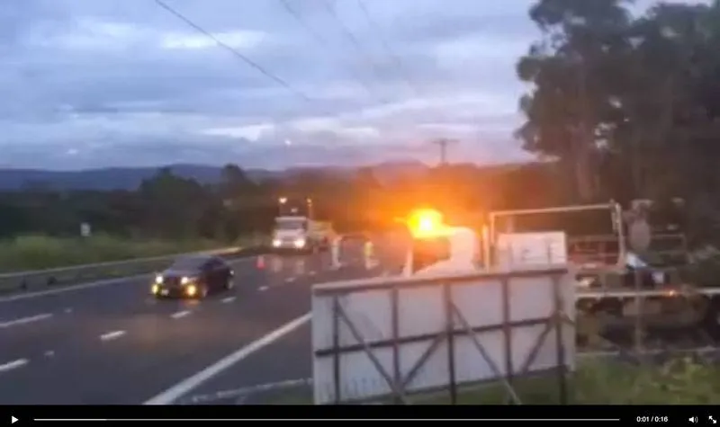 Dash camera view of a lane closure on the M1 at dusk, beacon flashing