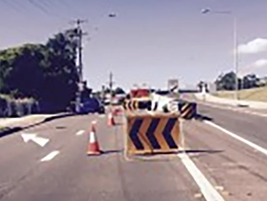 A chevron board and cones closing a lane